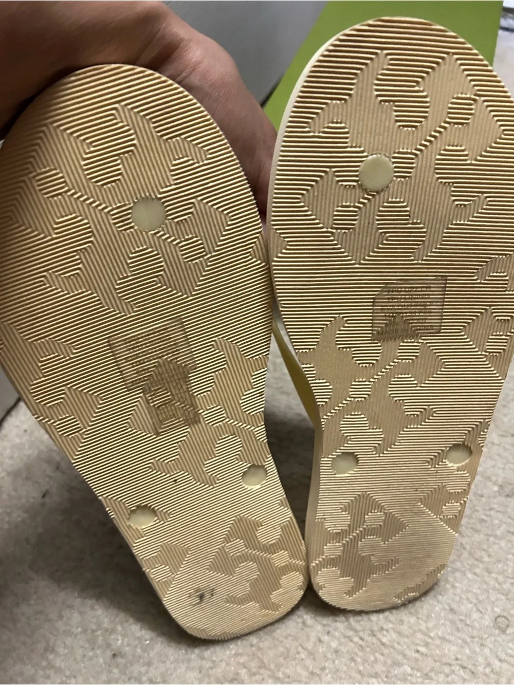 TORY BURCH KIRA padded flip flops in light yellow.